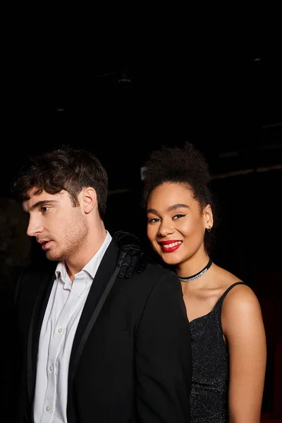 Cheerful african american woman with red lipstick smiling at camera next to her handsome boyfriend — Stock Photo