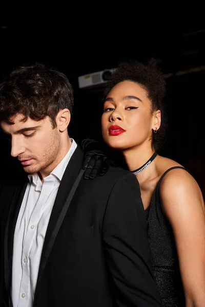 Appealing multicultural elegant couple in evening attires posing together at cinema, Valentines day — Stock Photo