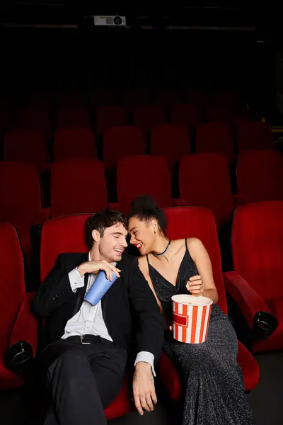 Appealing cheerful couple in evening attires having great time at cinema on date, Valentines day — Stock Photo