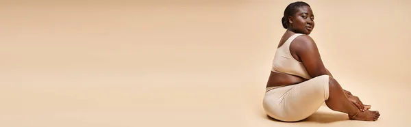 Body positive banner, plus size african american woman in underwear posing against matching backdrop — Stock Photo