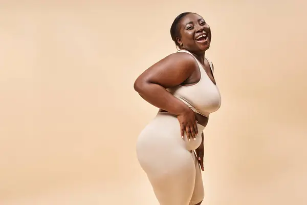 Cheerful african american plus size woman embracing self-love and confidence, body positive — Stock Photo