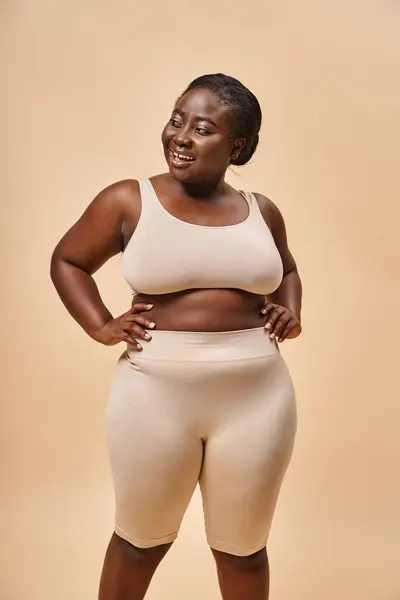 Happy plus size woman in underwear posing with hands on hips, body positive and female empowerment — Stock Photo