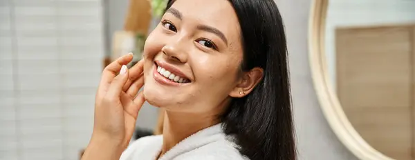Banner of happy young asian with acne-prone skin standing in modern bathroom and looking at camera — Stock Photo
