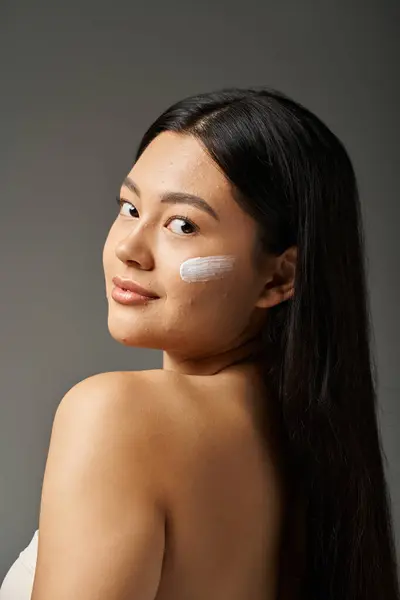 Young asian woman with brunette hair and acne prone skin looking at mirror in bathroom, banner — Stock Photo