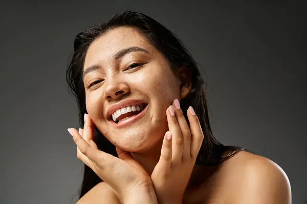 Young asian woman with brunette hair and acne prone skin looking at mirror in bathroom, banner — Stock Photo