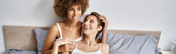 Happy african american woman with curly hair having great time with girlfriend in morning, banner — Stock Photo