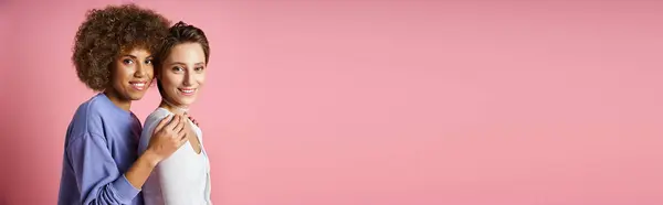 Portrait of young multicultural lgbtq couple in casual clothes looking at camera on pink, banner — Stock Photo