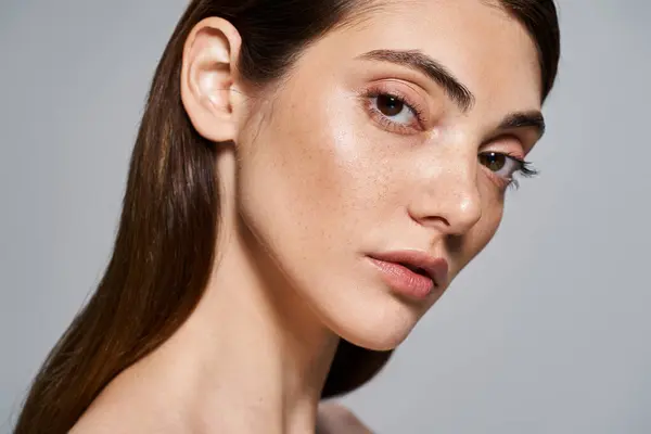 A young Caucasian woman with long brown hair and brown eyes exudes grace and charm in a studio setting. — Stock Photo