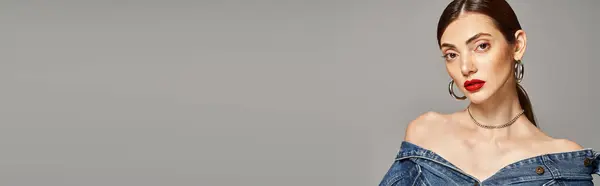 A young Caucasian woman with brunette hair stuns in a denim dress paired with bold red lipstick, banner — Stock Photo