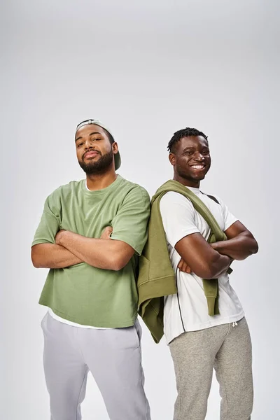 Juneteenth concept, two african american male friends standing with folded arms on grey background — Stock Photo