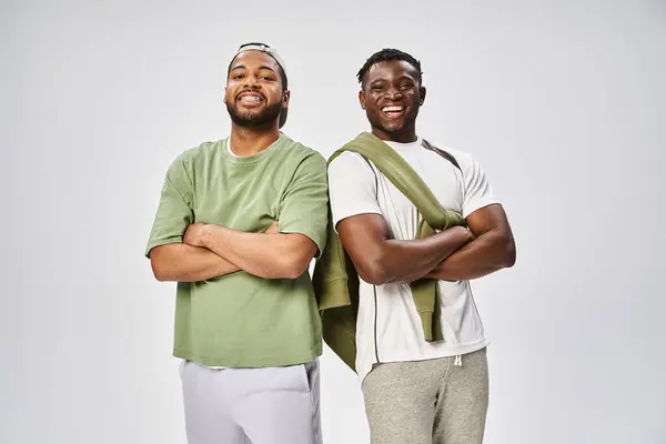 Juneteenth, positive african american friends standing with folded arms on grey background — Stock Photo