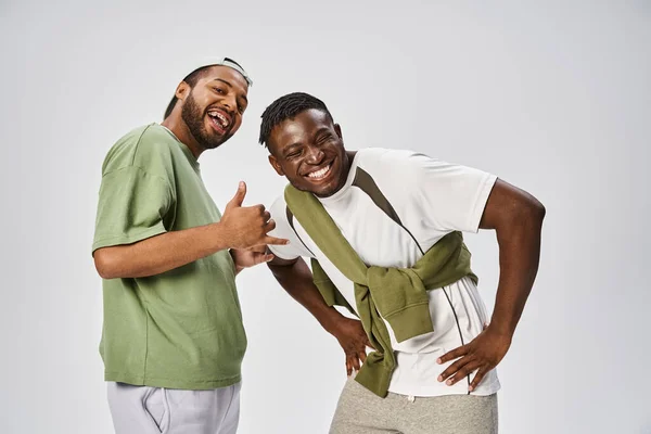 Happy Juneteenth celebration, excited and young african american friends hugging on grey background — Stock Photo
