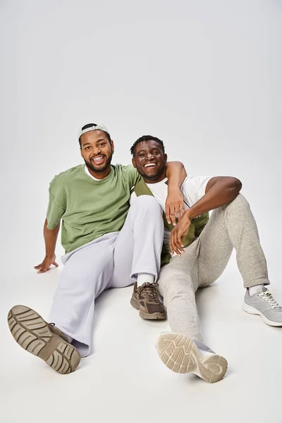 Happy Juneteenth celebration, excited and young african american mates hugging on grey background — Stock Photo