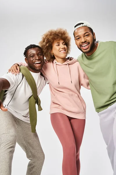 Excited african american men and woman standing on grey background, Juneteenth celebration — Stock Photo