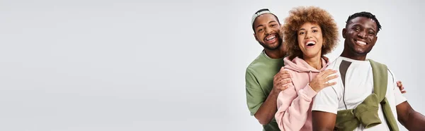 Joyous african american friends looking at camera on grey backdrop, Juneteenth celebration banner — Stock Photo