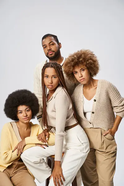 Group of elegant african american women and man standing together on grey background, Juneteenth — Stock Photo