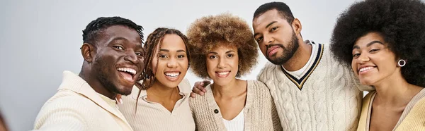 Group of happy african american friends bonding and hugging on grey background, Juneteenth banner — Stock Photo