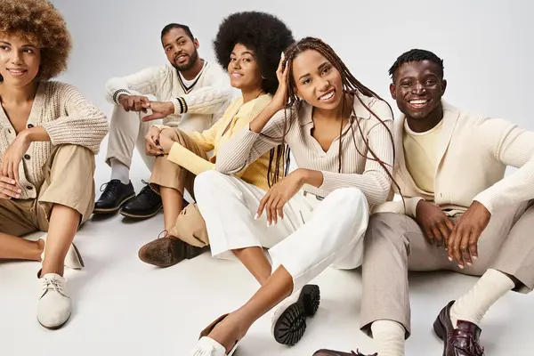 Group of cheerful african american people in casual attire sitting on grey background, Juneteenth — Stock Photo