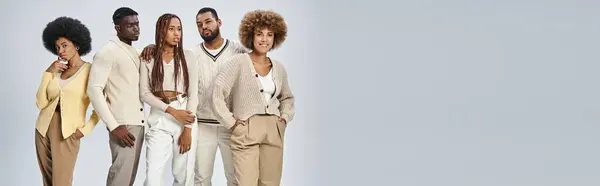 Stylish african american people in casual attire standing on grey background, Juneteenth concept — Stock Photo