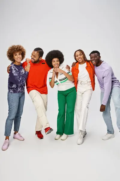 Cheerful african american community in colorful casual wear standing together on grey background — Stock Photo