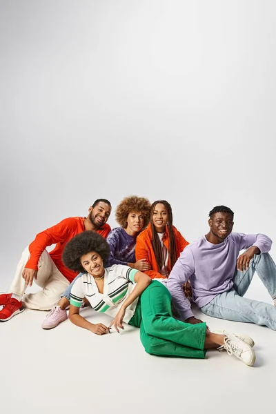 Trendy african american friends in casual wear spending time together on grey backdrop, Juneteenth — Stock Photo