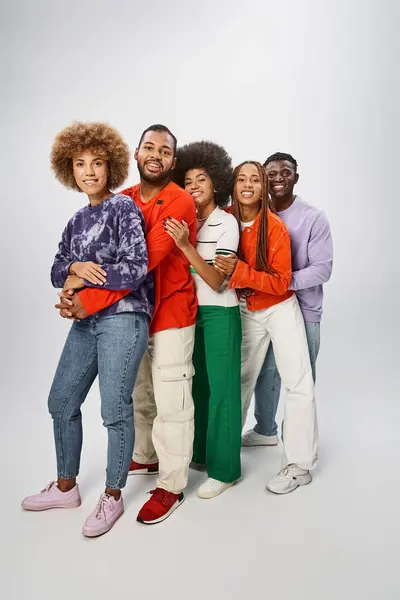 Joyful african american people in casual attire posing together on grey backdrop, Juneteenth concept — Stock Photo