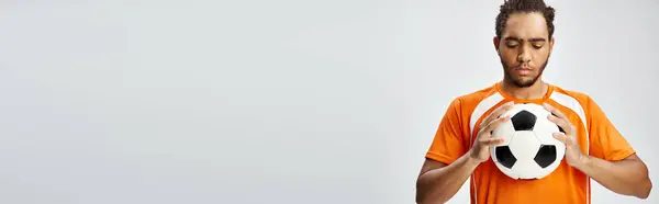 Appealing athletic african american man in sportwear looking at football in his hands, banner — Stock Photo