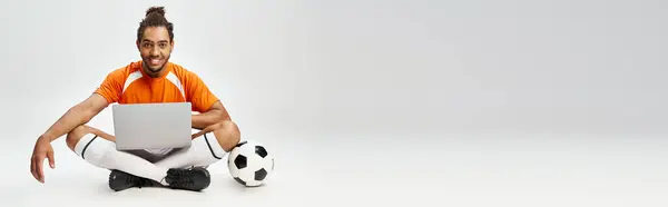 Jolly african american man with football and laptop looking at camera, online betting, banner — Stock Photo