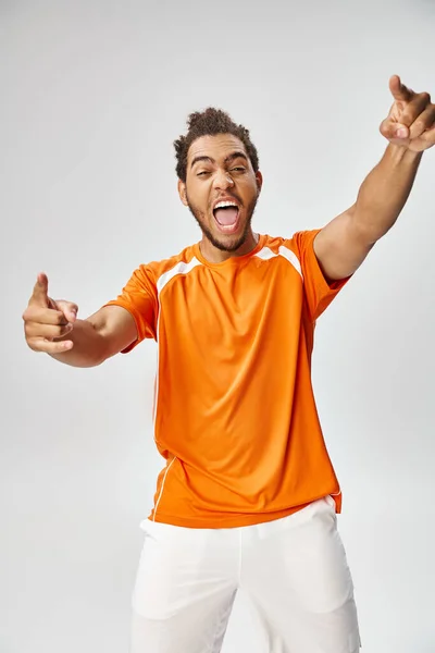 Joyous sporty african american man gesturing and pointing actively, online betting concept — Stock Photo