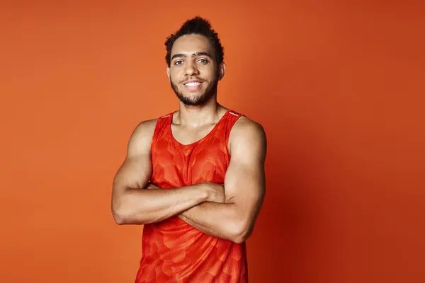 Cheerful athletic african american man in sportwear posing with arms crossed and looking at camera — Stock Photo