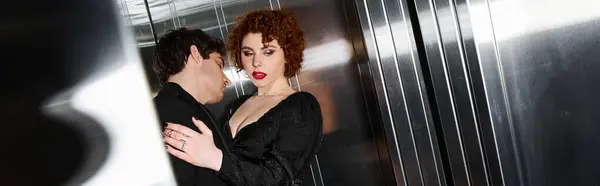 Sexy couple in stylish evening black dress and suit hugging in elevator after date, banner — Stock Photo