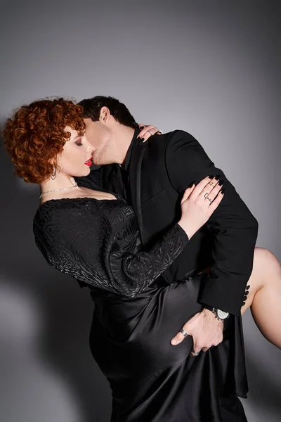 Handsome man holding his beautiful girlfriend tight preparing to kiss passionately, sexy couple — Stock Photo