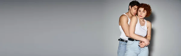 Handsome man hugging his beautiful girlfriend while she looking at camera, sexy couple, banner — Stock Photo