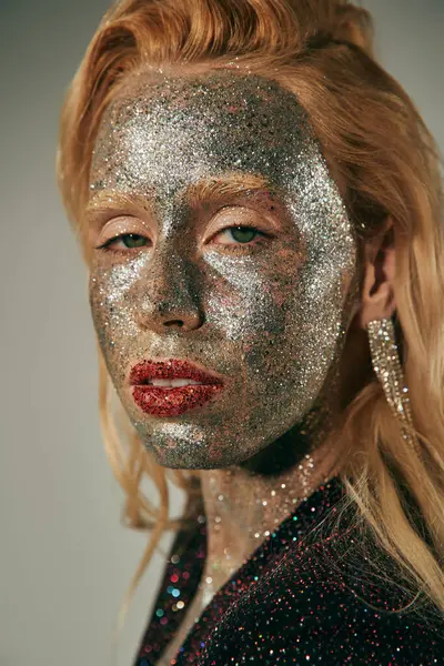 Portrait, pretty woman with green eyes and glitter all over body and face posing on grey backdrop — Stock Photo