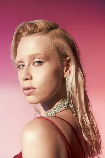 Good looking young woman with long blonde hair wearing accessories and looking straight at camera — Stock Photo