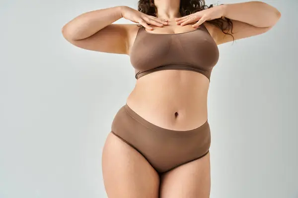 Cropped shot of body attractive curvy woman in underwear touching to neckline with hands — Stock Photo