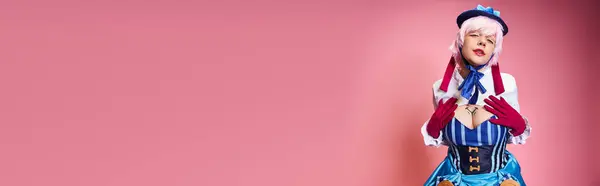 Alluring female cosplayer in blue hat and vivid dress looking at camera on pink backdrop, banner — Stock Photo