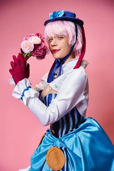 Attractive cute female cosplayer in vibrant costume holding pink flowers and looking at camera — Stock Photo