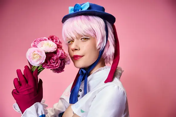 Alluring cute female cosplayer in vibrant costume holding pink flowers and looking at camera — Stock Photo