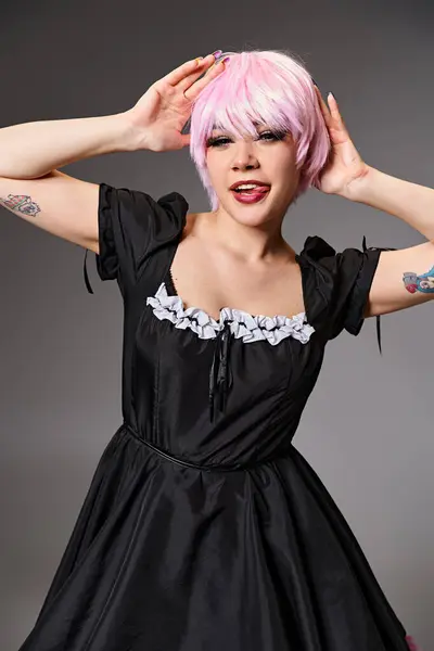 Joyeuse séduisante cosplayer féminin en robe vibrante sortant de sa langue et regardant la caméra — Photo de stock