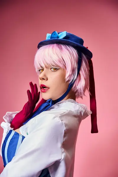 Appealing woman cosplaying anime character with blue hat and red gloves and looking at camera — Foto stock