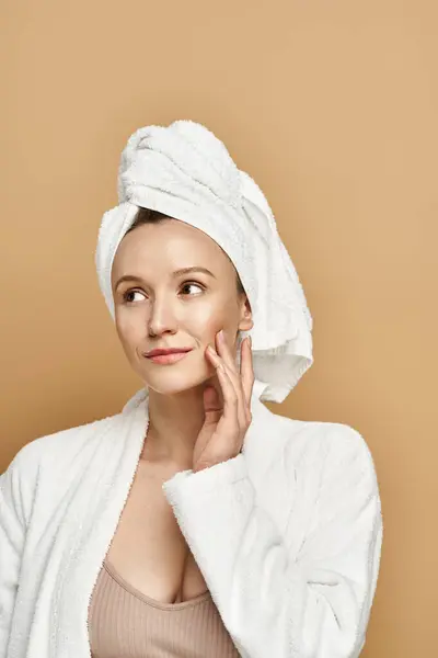 A beautiful woman with a towel wrapped around her head, exuding natural beauty and tranquility. — Stock Photo