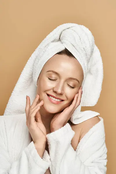 An attractive woman with natural beauty, actively posing with a towel draped elegantly over her head. — Stock Photo