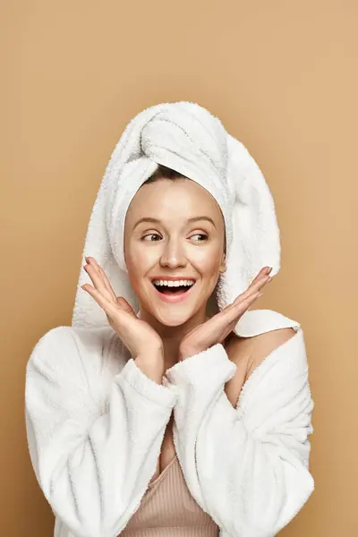 A stunning woman, radiating natural beauty, wears a towel on her head in a regal pose. — Stock Photo