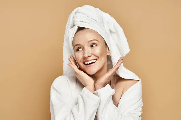 An attractive woman with natural beauty demonstrates elegance while wearing a towel turban on her head. — Stock Photo