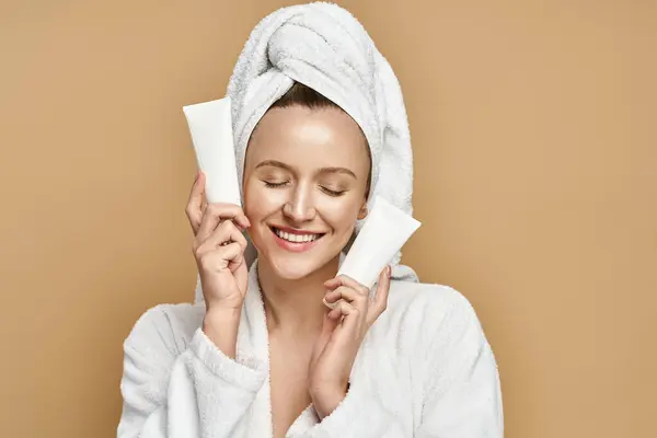 A woman in a bathrobe mysteriously holding a cream over her face, exuding elegance and allure. — Stock Photo