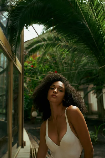 Young african american woman in bathing suit posing green urban garden, elegance and diversity — Stock Photo