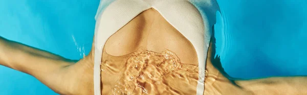 Banner of cropped african american woman swimming on her back in clear pool water, tranquility — Stock Photo