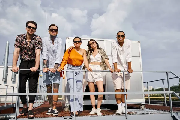 Joyous young multicultural friends in casual urban attires posing on rooftop and looking at camera — Stock Photo