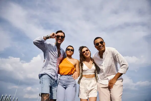 Happy diverse good looking friends with trendy sunglasses posing joyfully on rooftop together — Stock Photo